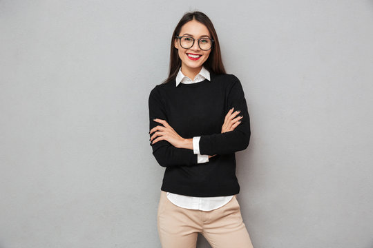 Cheerful asian woman in business clothes and eyeglasses