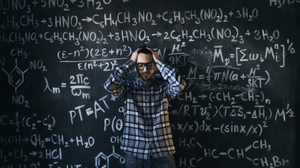 scientist man disappointed about problems experiment in chemical and mathematical equations room