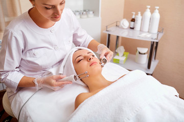 Obraz na płótnie Canvas Woman on facial skincare procedure. Hardware cosmetology.