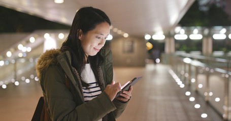 Young Woman use of smart phone in city at night