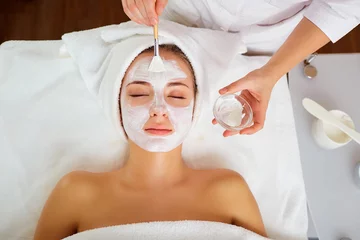 Foto op Canvas Woman in mask on face in spa beauty salon. © Studio Romantic