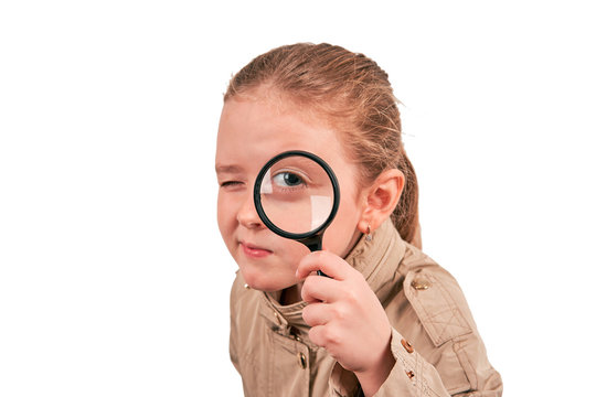 Girl Detective With Magnifying Glass In A Raincoat On A White Background