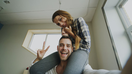POV shot of cute and loving couple talking online video chat holding smartphone and chatting to...