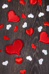 Red hearts on a wooden background.
