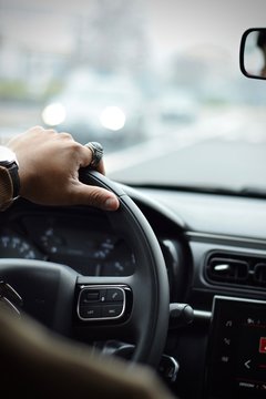 Man Hand Close Up Driving A Car