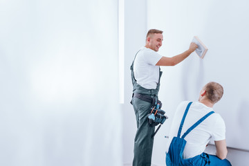 Home renovation crew preparing wall
