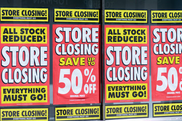 Store Closing signs shop window in Bedford, Bedfordshire, England