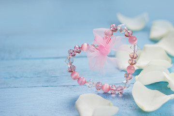 Pink heart and white roses  petals on blue wooden table. Valentine's day ,Love ,Romantic, Wedding  or Mother's day background