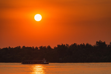Ferry boat in the Chao Phraya River at estuary in sunsrt time at Samut Prakan, Thailand.