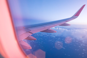 SuBeautiful sunset with cloudy sky from the airplane window.