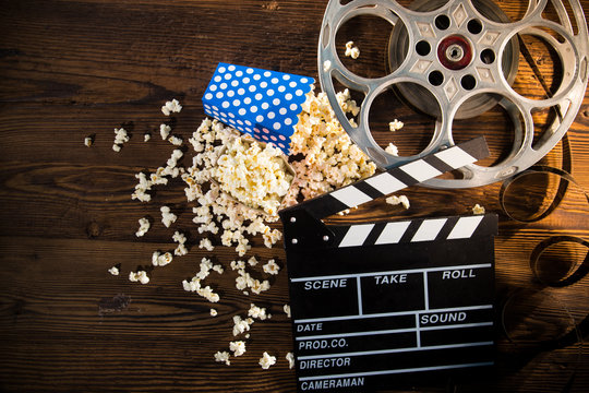 Cinema concept of vintage film reel with popcorn.