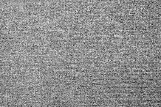 close up of monochrome grey carpet texture background from above