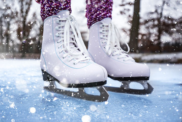 Close-up of woman ice skating on a pond.