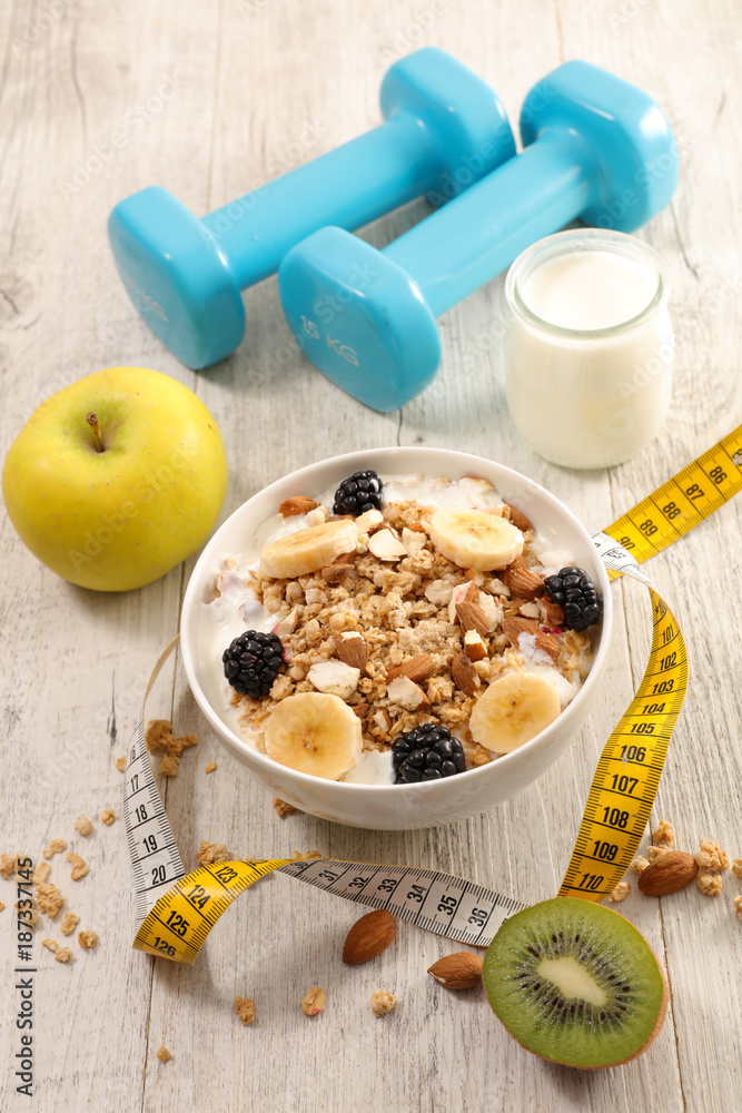 Wall mural bowl of cereal, fruit and dumbbell