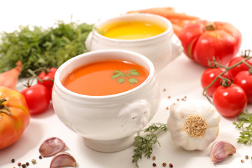 tomato and carrot soup on white background