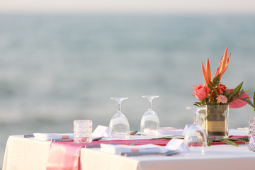 Wedding table set up on the beach. Wedding the tropical theme outdoor dinner table on beach Pattaya Thailand. Impressive and beautiful wedding set up outdoor on the beach.