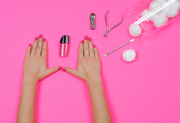 Nail salon. Beautiful female hands with pink nail polish