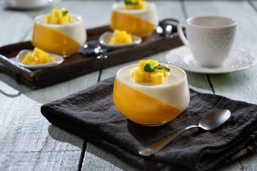 Panna cotta dessert  on a wooden board and coffee mug