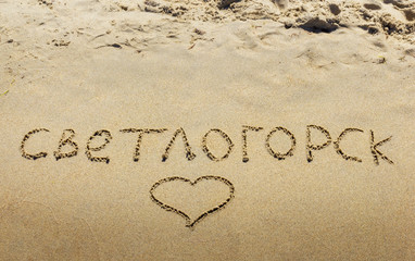 Inscription on wet sand Svetlogorsk . Russia.