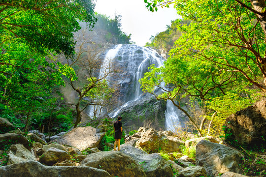 khlong lan waterfall with pretty happy women in National park, Kamphaeng Phet Province, Thailand