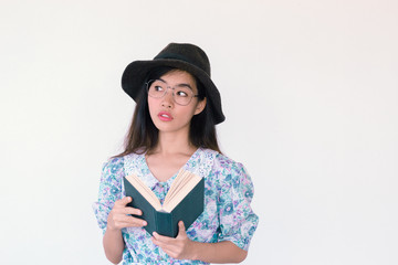 Fashion Portrait of Young cute asian woman wearing vintage dress holding a book