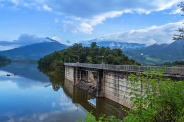 Hydroelectric dam with trumpets with mountain view.