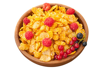 Breakfast of cornflakes with berries in wooden bowl