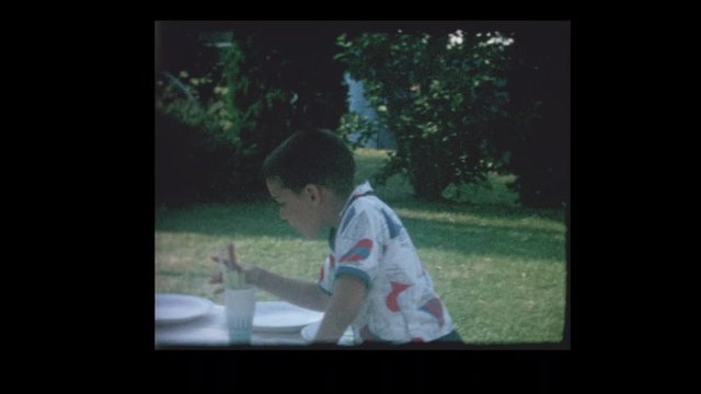 1964 Young boy sets up picnic table
