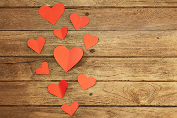 Red heart paper on wooden background