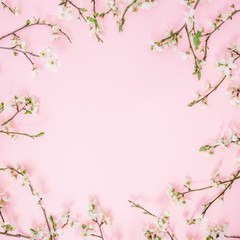 Fototapeta na wymiar Floral frame of spring flowers isolated on pink background. Flat lay, top view. Spring time background.