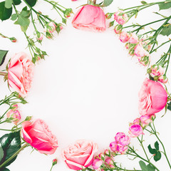 Floral round frame with roses and leaves on white background. Flat lay, top view. Frame background