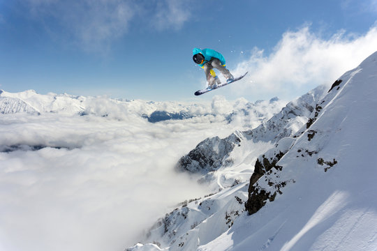Flying snowboarder on mountains. Extreme winter sport. © Vasily Merkushev