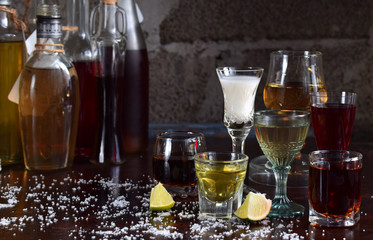 Selection of alcoholic drinks. Set of wine, brandy, liqueur, tincture, cognac, whiskey in glasses, bottles. Large variety of alcohol and spirits for making cocktails and drink. Copy space for text