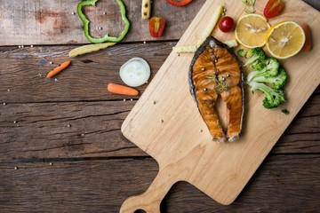 Salmon fillets. Grilled salmon, salmon steak on old wooden table, vintage style
