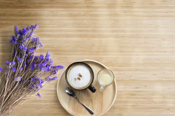 Obraz na płótnie Canvas morning coffee on wood table with nice flower
