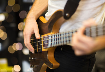 close up of musician with guitar at music studio