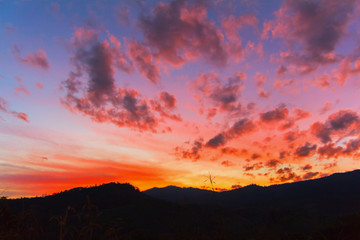 Red from orange clouds at sunset time.