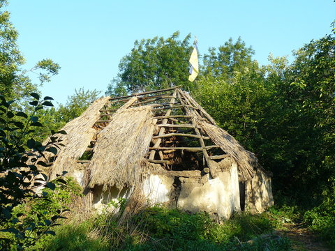classical Ukrainian hut - mazanka, aged more than a hundred years, abandoned, in the wilderness in Poltava region