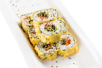 Tempura maki sushi - deep fried hot sushi roll with salmon, tuna, eel, chukka and sesame