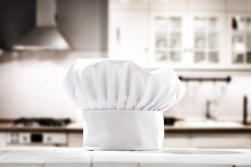 Fototapeta na wymiar cook hat and kitchen interior 