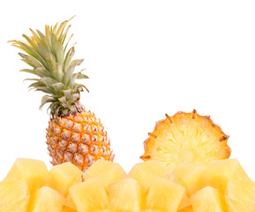 Fototapeta na wymiar Pieces of pineapple and whole pineapple