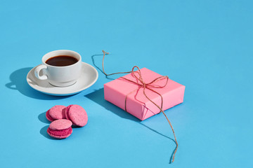 Valentine's day greeting card. White coffee cup, pink macaroons 