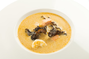 Thai coconut milk soup Tom Kha with salmon, shrimp and mushrooms