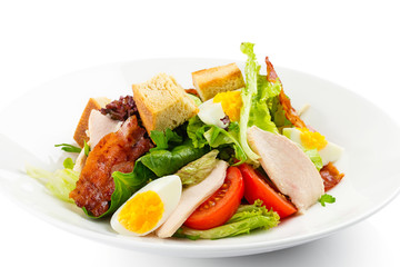 Fresh green salad with chicken, bacon, eggs, tomatoes and croutons