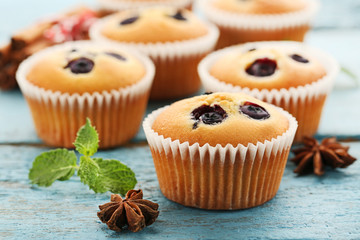 Sweet blueberry muffins on grey wooden table