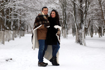 Obraz premium A young couple walk in a winter park