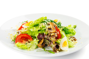 Fresh green salad with tomatoes, roasted champignon, eggs and bulgur