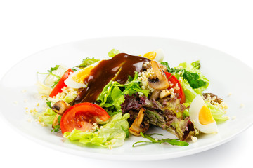 Fresh green salad with tomatoes, roasted champignon, eggs and bulgur