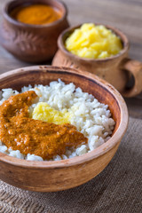 Bowl of rice with Indian butter sauce and Ghee clarified butter
