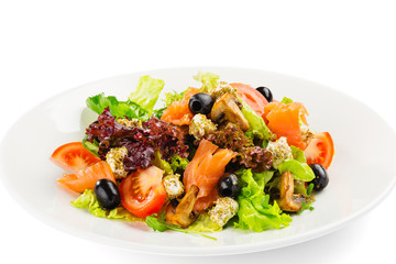 Fresh green salad with tomatoes, salmon, olives, champignon and feta